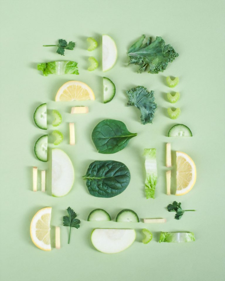 Green vegetables and fruit slices artfully arranged